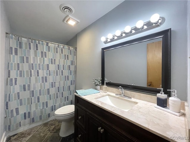 bathroom featuring toilet, vanity, a shower with shower curtain, and tile patterned flooring