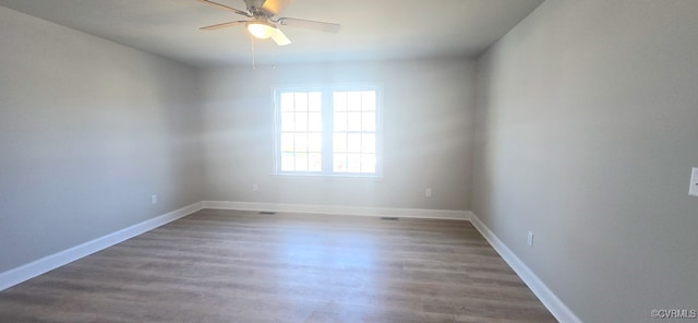 empty room featuring ceiling fan and dark hardwood / wood-style floors