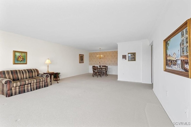 carpeted living room featuring ornamental molding and a chandelier