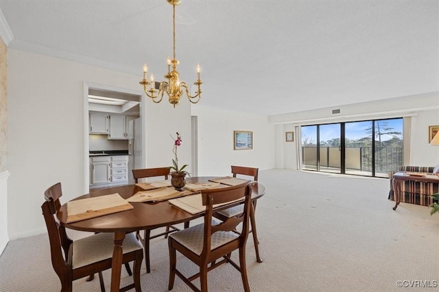 carpeted dining space with a chandelier