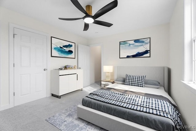 carpeted bedroom featuring ceiling fan