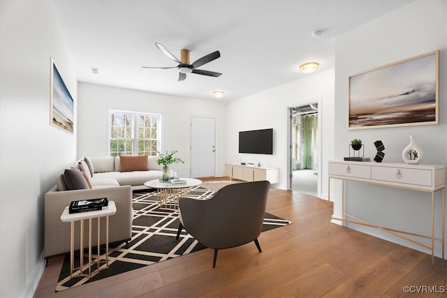 living room featuring ceiling fan and light hardwood / wood-style flooring