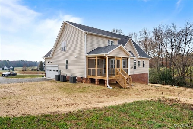 rear view of property featuring cooling unit and a sunroom