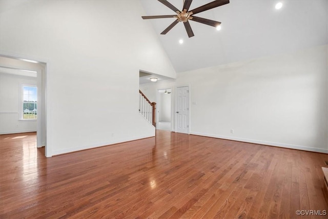 unfurnished living room with ceiling fan, hardwood / wood-style flooring, and high vaulted ceiling