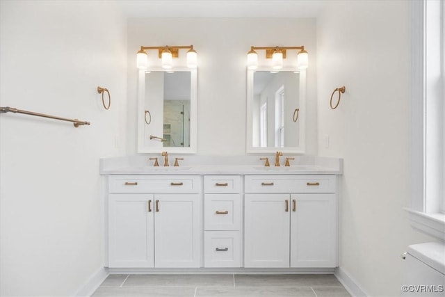 bathroom featuring tile patterned floors, vanity, and toilet