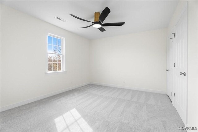 spare room featuring ceiling fan and light colored carpet