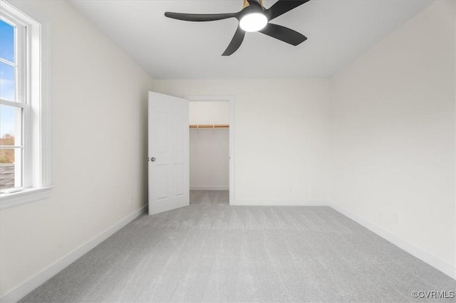 unfurnished bedroom with ceiling fan, a closet, and light colored carpet