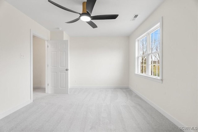 carpeted empty room featuring ceiling fan