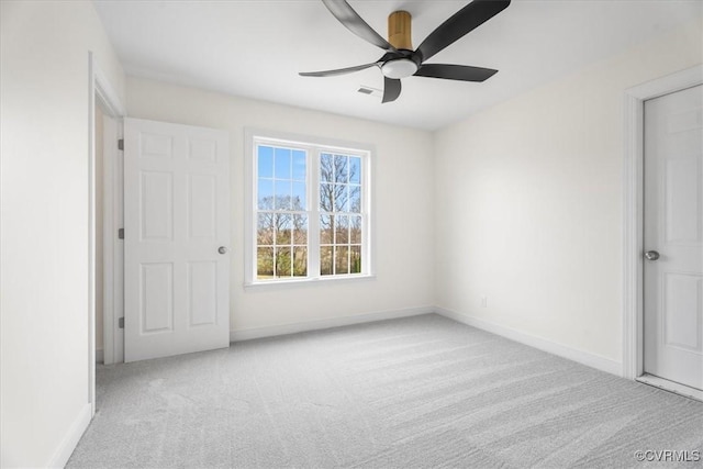 carpeted spare room with ceiling fan