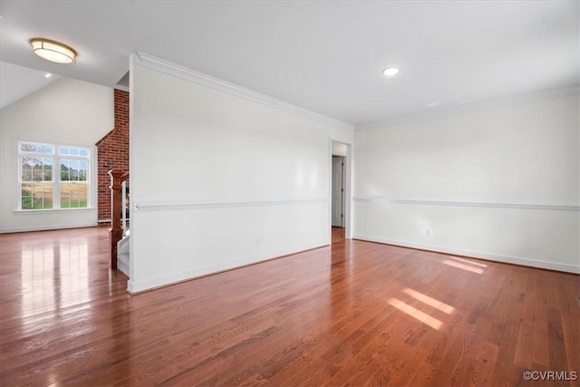 interior space featuring hardwood / wood-style flooring, crown molding, and vaulted ceiling