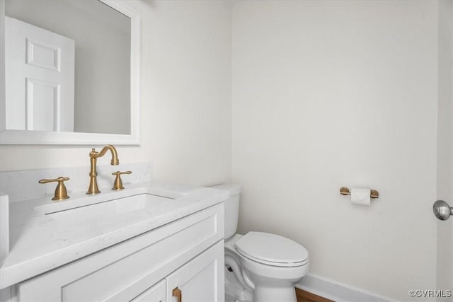 bathroom with toilet and vanity