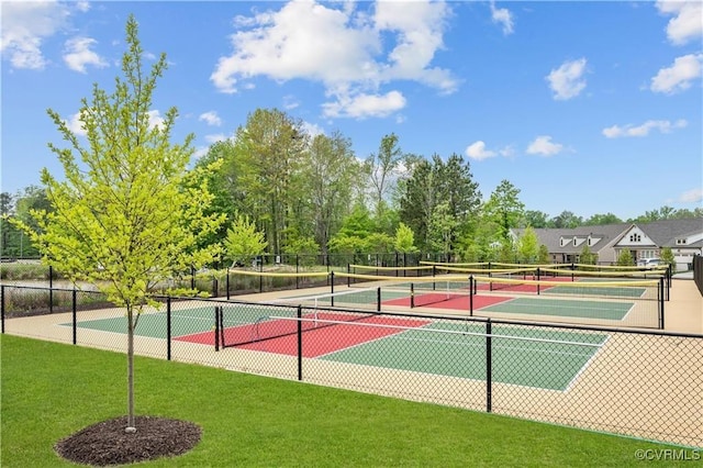 view of tennis court featuring a yard