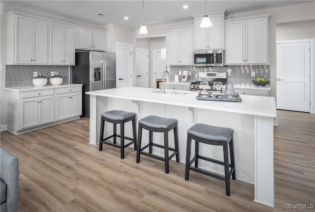 kitchen featuring sink, stainless steel appliances, and white cabinetry