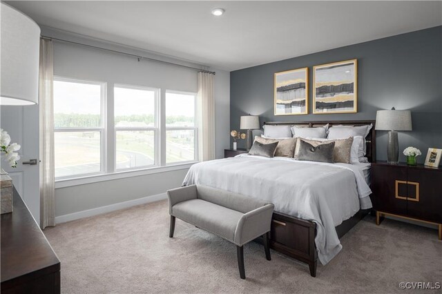 carpeted bedroom featuring multiple windows