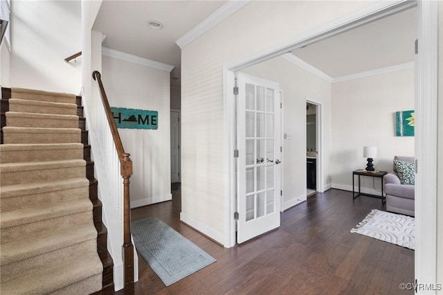 entrance foyer featuring dark hardwood / wood-style flooring and crown molding