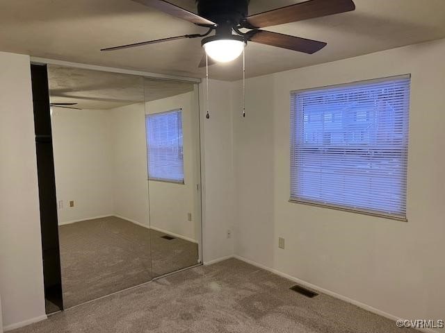 unfurnished bedroom with ceiling fan and carpet flooring