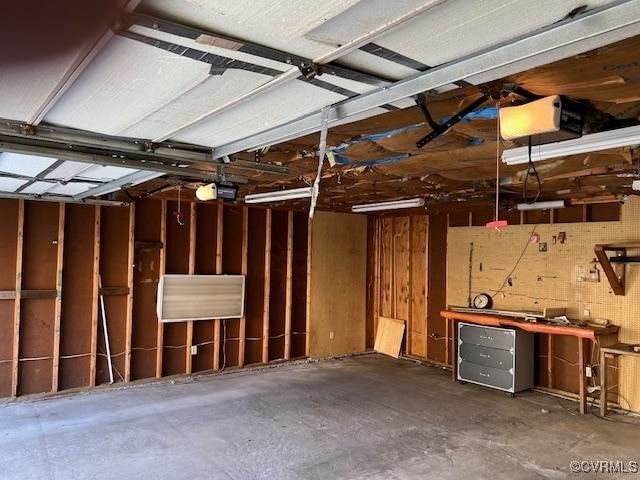 garage with a garage door opener and a workshop area