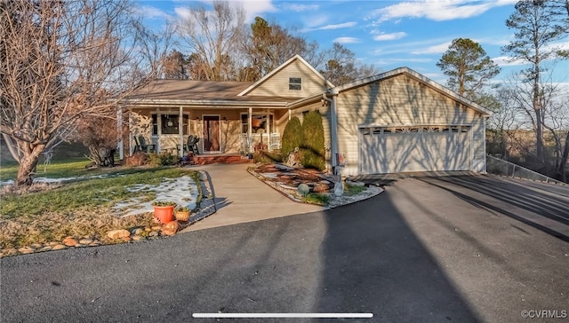 view of property with a garage and covered porch