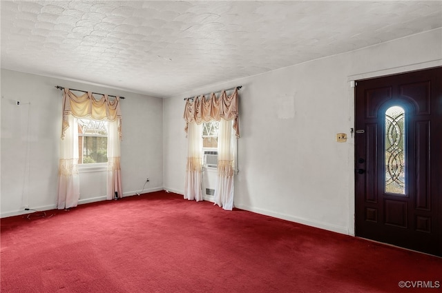 foyer entrance featuring carpet and a textured ceiling