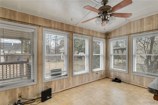 sunroom with plenty of natural light, lofted ceiling, and ceiling fan