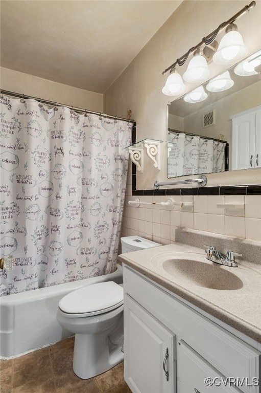 bathroom with tile patterned flooring, vanity, tile walls, and toilet