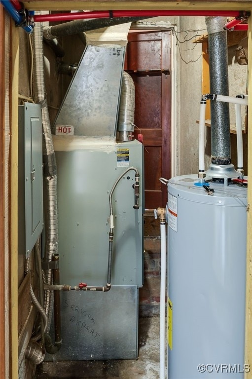 utility room featuring water heater and electric panel