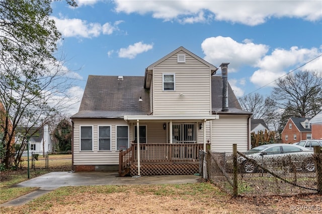 rear view of property featuring covered porch