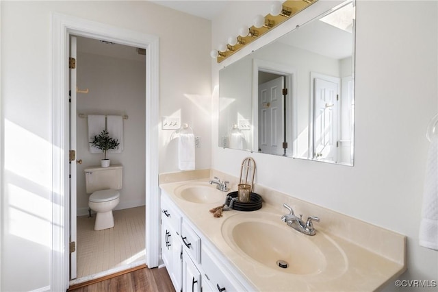 bathroom with vanity, hardwood / wood-style floors, and toilet