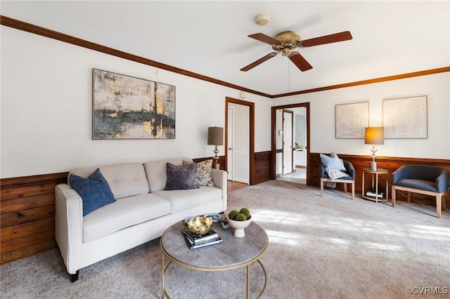 living room featuring crown molding, carpet floors, and ceiling fan