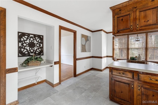 kitchen featuring crown molding and hanging light fixtures