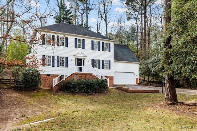 colonial-style house with a garage and a front lawn