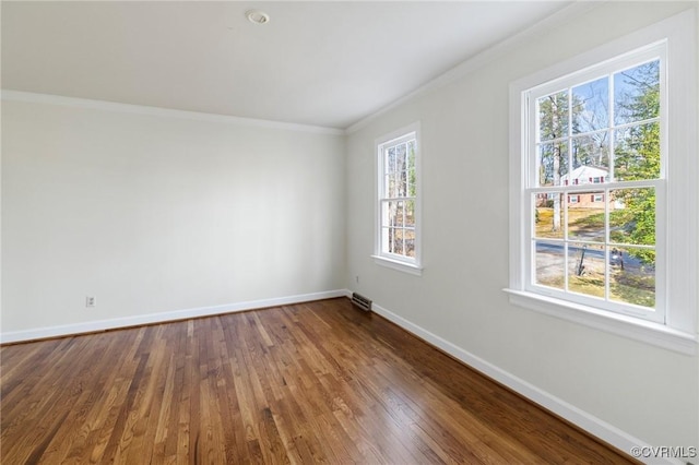 spare room featuring wood-type flooring and ornamental molding