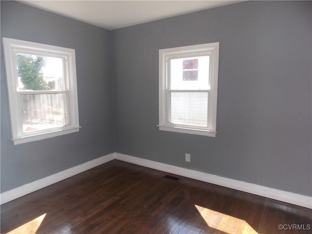 unfurnished room featuring dark hardwood / wood-style floors