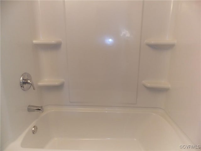 bathroom with bathing tub / shower combination