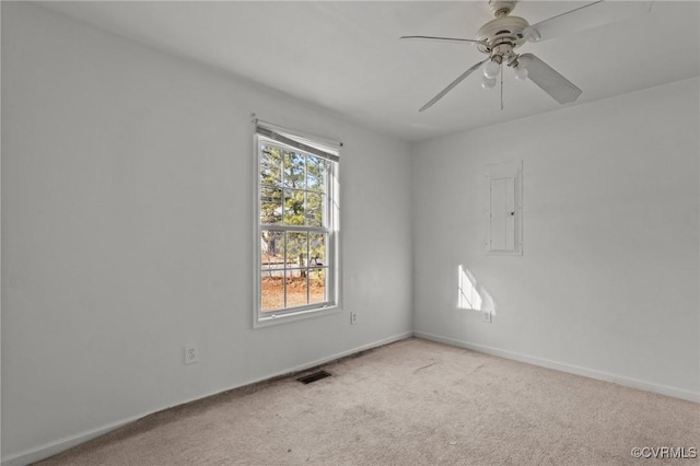 spare room with ceiling fan and light carpet