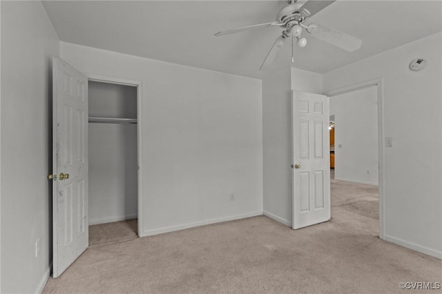 unfurnished bedroom featuring light carpet, a closet, and ceiling fan