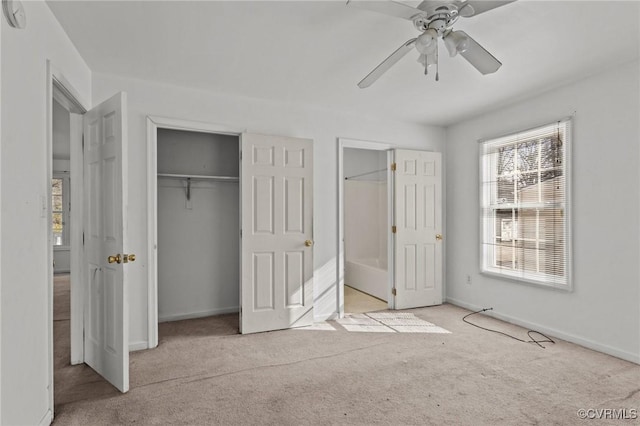 unfurnished bedroom with multiple windows, light colored carpet, and ceiling fan