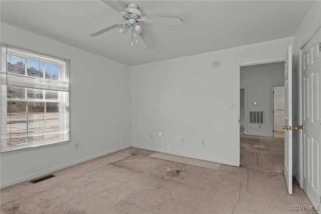 unfurnished room with light carpet and ceiling fan