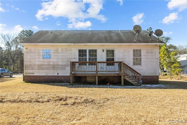 back of house featuring a deck and a lawn