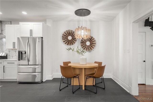 tiled dining space with an inviting chandelier