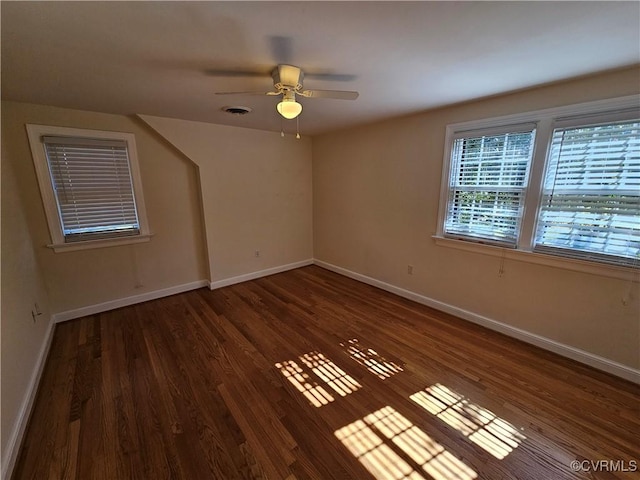 spare room featuring ceiling fan and dark hardwood / wood-style flooring