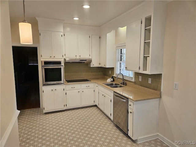 kitchen with tasteful backsplash, sink, white cabinetry, hanging light fixtures, and stainless steel appliances