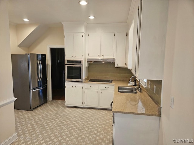 kitchen featuring backsplash, sink, white cabinetry, light stone countertops, and appliances with stainless steel finishes