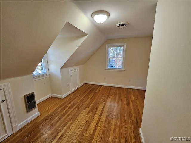 bonus room featuring light hardwood / wood-style floors and vaulted ceiling