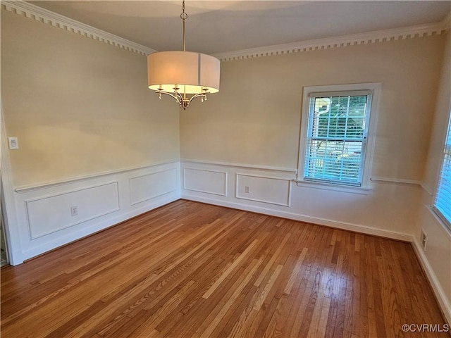 unfurnished room featuring wood-type flooring and crown molding