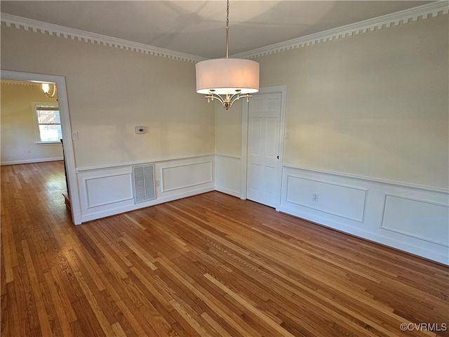 unfurnished dining area featuring wood-type flooring and ornamental molding