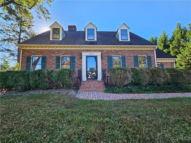 cape cod-style house with a front lawn