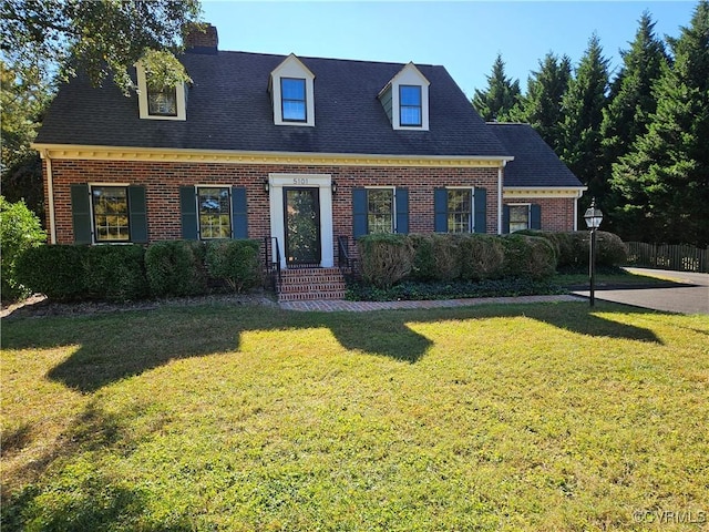 cape cod house with a front lawn