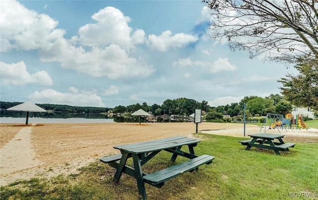 view of property's community featuring a playground and a water view