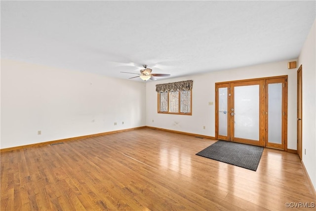 foyer entrance with ceiling fan and light wood-type flooring